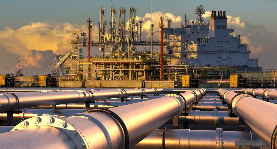 Image of pipes leading to a large ship